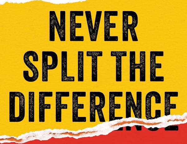 Cropped image of the book "Never Split The Difference", showing these words front and center